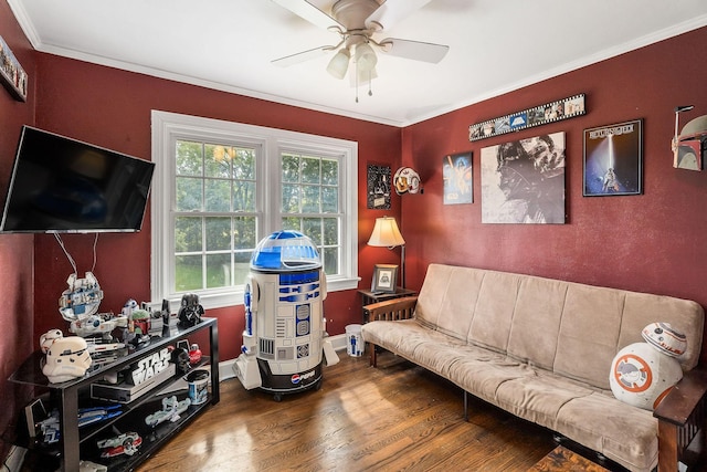 living room featuring crown molding, ceiling fan, and wood-type flooring