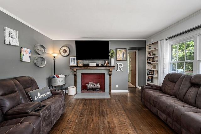 living room featuring built in features, ornamental molding, dark hardwood / wood-style floors, and a brick fireplace