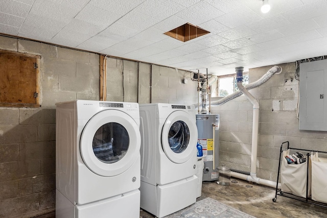 washroom featuring electric panel, water heater, and washer and clothes dryer