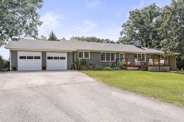 ranch-style house with a front lawn, a garage, and a deck