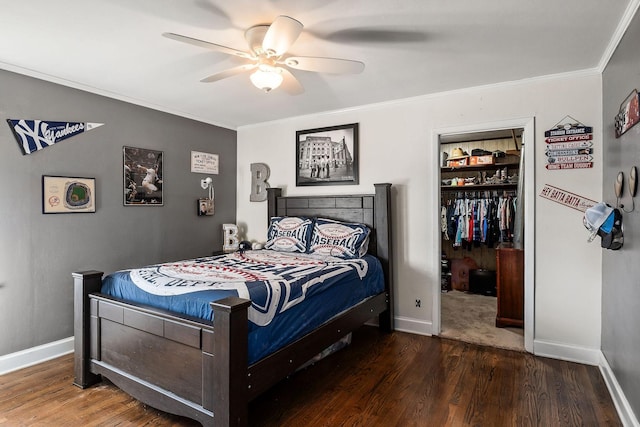 bedroom with a closet, a spacious closet, ceiling fan, and dark hardwood / wood-style floors