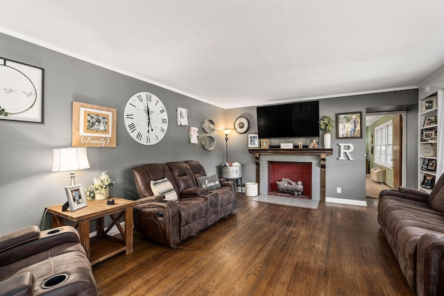 living room with a brick fireplace, dark hardwood / wood-style floors, and ornamental molding