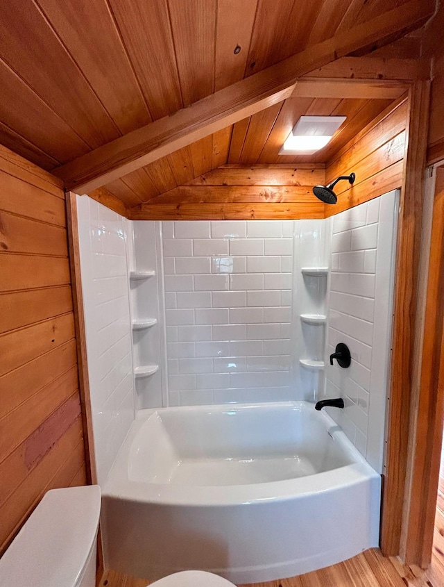 bathroom with wooden walls, wood ceiling, and bathtub / shower combination