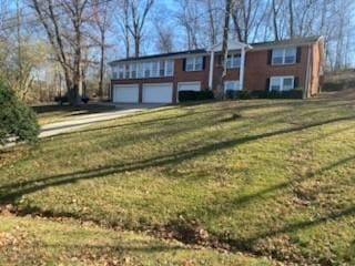 view of front facade with a garage and a front lawn