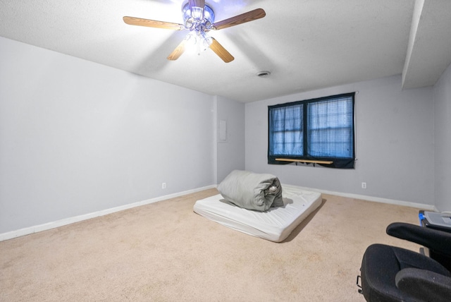 living area with carpet, visible vents, baseboards, and a ceiling fan