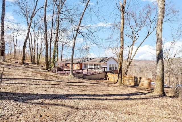 view of yard with a wooden deck and fence