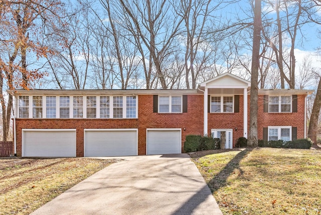 view of front facade featuring a garage, concrete driveway, brick siding, and a front yard