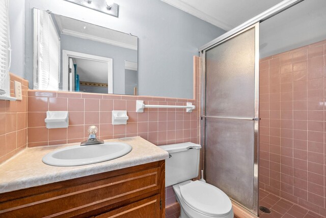 bathroom with ornamental molding, a stall shower, vanity, and toilet