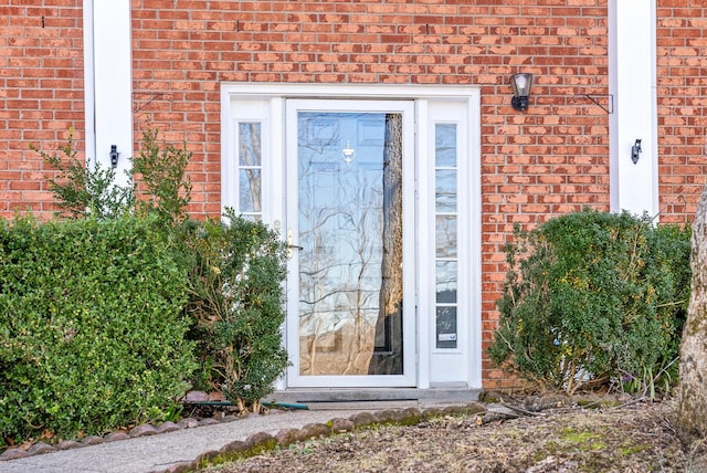 property entrance with brick siding