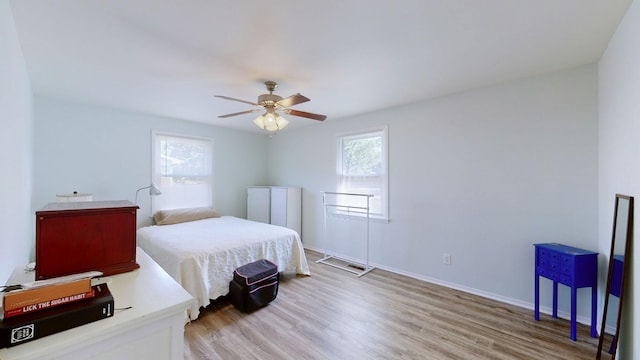 bedroom featuring light hardwood / wood-style floors and ceiling fan