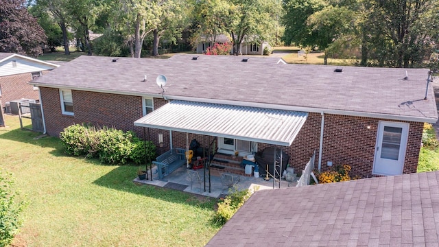 back of house featuring central AC unit, a yard, and a patio