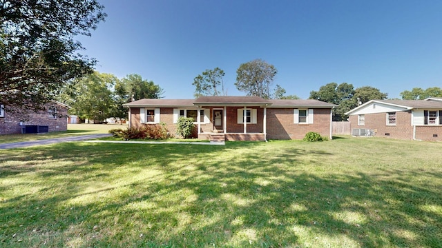 single story home featuring central AC, covered porch, and a front yard