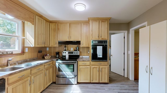 kitchen featuring light brown cabinetry, dark hardwood / wood-style flooring, sink, and black appliances