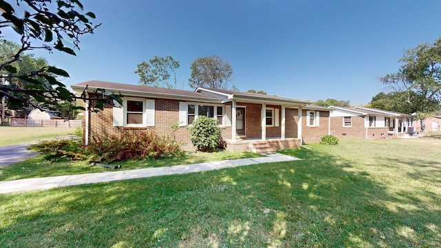 single story home featuring a front lawn