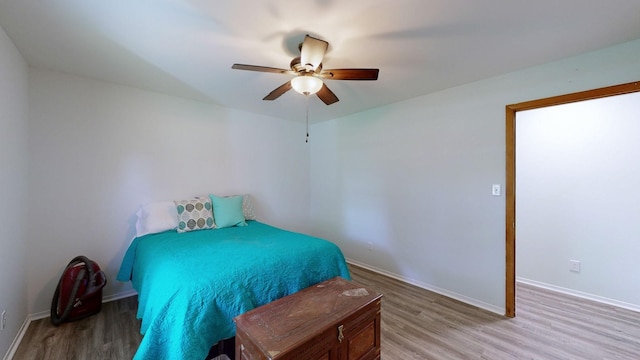 bedroom with light hardwood / wood-style flooring and ceiling fan