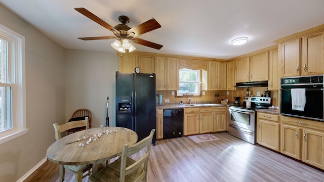 kitchen with light brown cabinetry, light wood-type flooring, ceiling fan, and black appliances