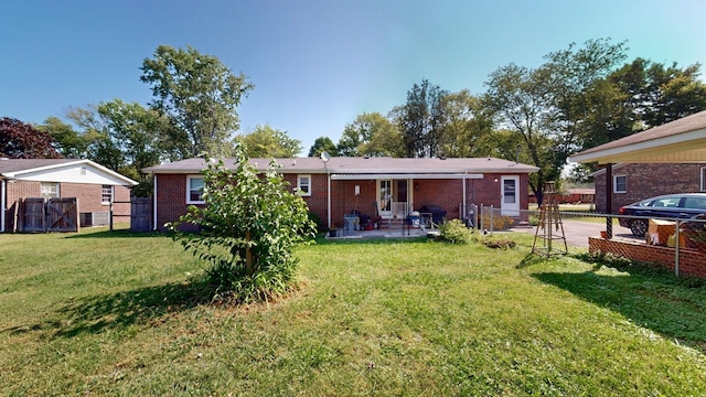 rear view of house featuring a patio and a lawn