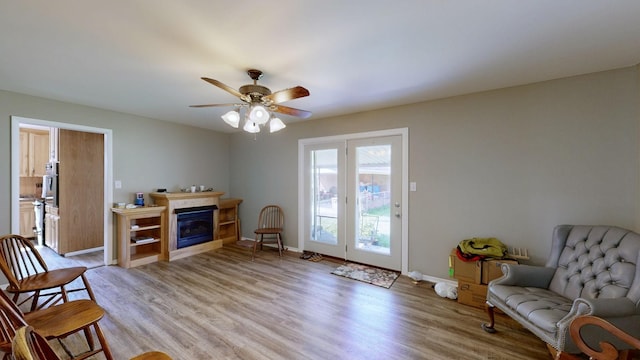 sitting room featuring ceiling fan and light hardwood / wood-style flooring