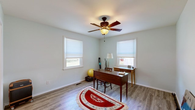 office with plenty of natural light, ceiling fan, and wood-type flooring