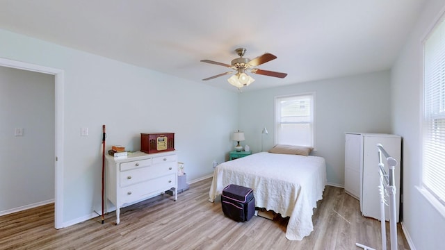 bedroom with light hardwood / wood-style floors and ceiling fan