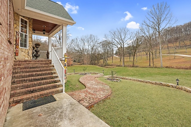 view of yard featuring covered porch