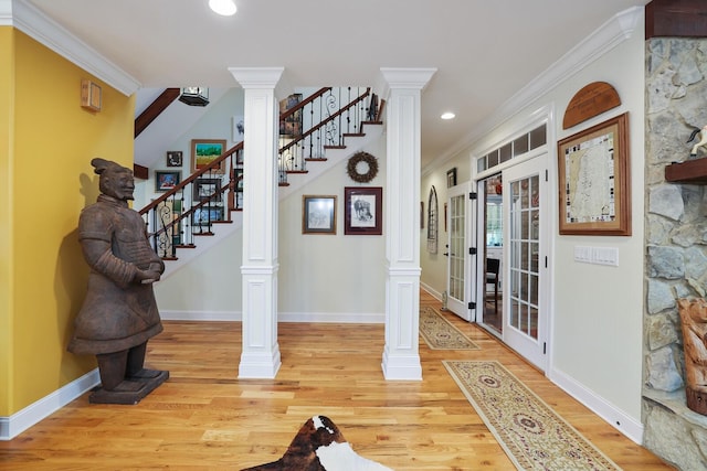 foyer featuring french doors, hardwood / wood-style flooring, and ornamental molding