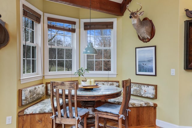 dining area featuring beam ceiling