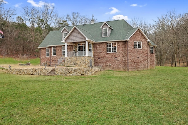 view of front of property with covered porch and a front yard