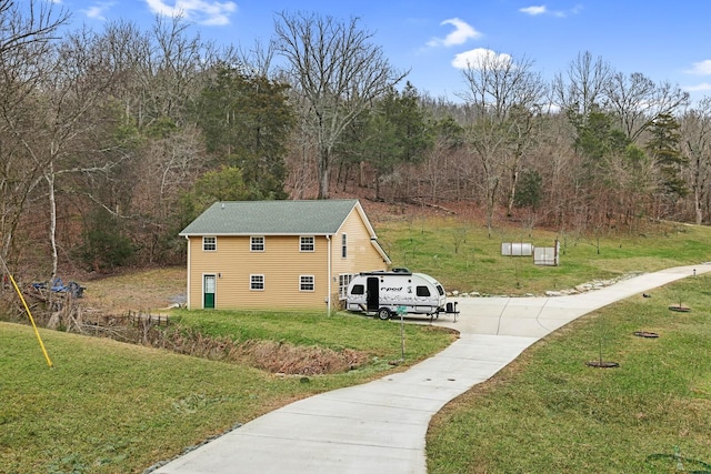 view of side of property with a yard