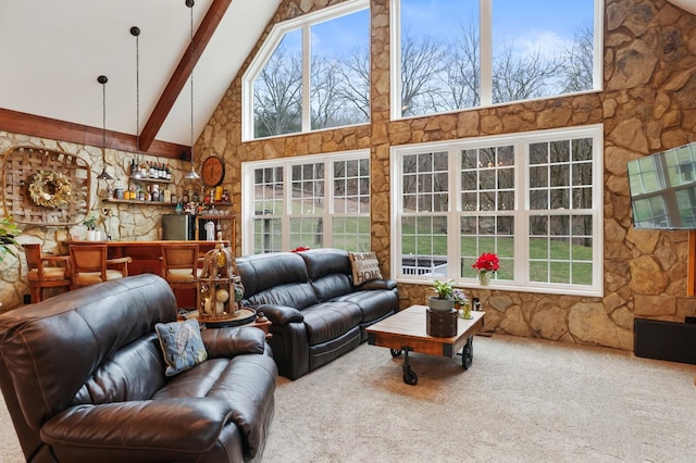 carpeted living room featuring beamed ceiling, indoor bar, and high vaulted ceiling