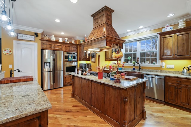 kitchen featuring appliances with stainless steel finishes, light stone counters, ornamental molding, a center island, and hanging light fixtures