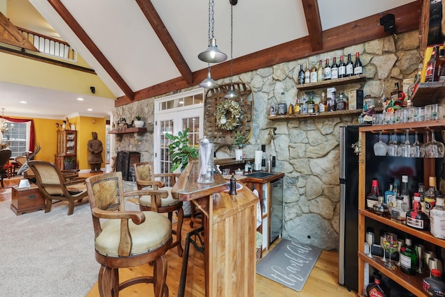 bar featuring beam ceiling, high vaulted ceiling, plenty of natural light, pendant lighting, and a fireplace