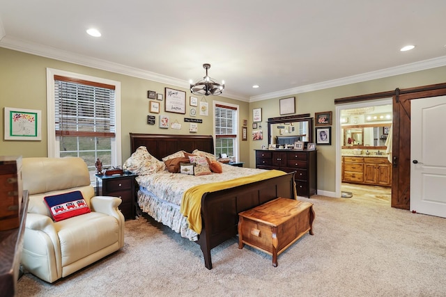 carpeted bedroom with connected bathroom, crown molding, a barn door, and an inviting chandelier