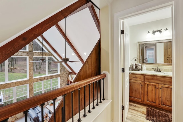 interior space featuring beamed ceiling, vanity, hardwood / wood-style flooring, and ceiling fan