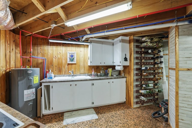 basement with sink, wood walls, and water heater