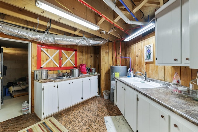 laundry room featuring sink and water heater