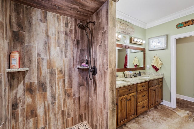 bathroom featuring a tile shower, vanity, and ornamental molding