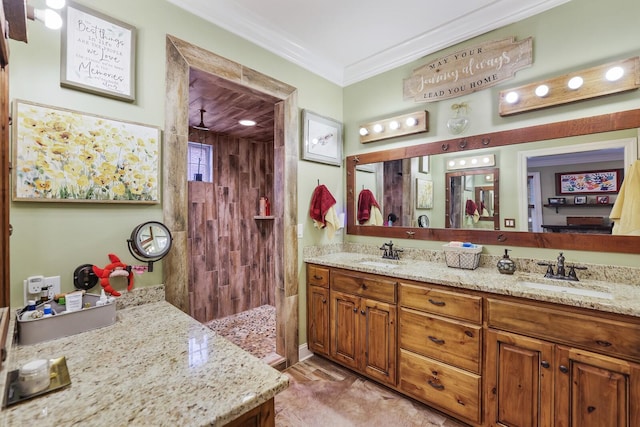 bathroom featuring a shower, vanity, and crown molding