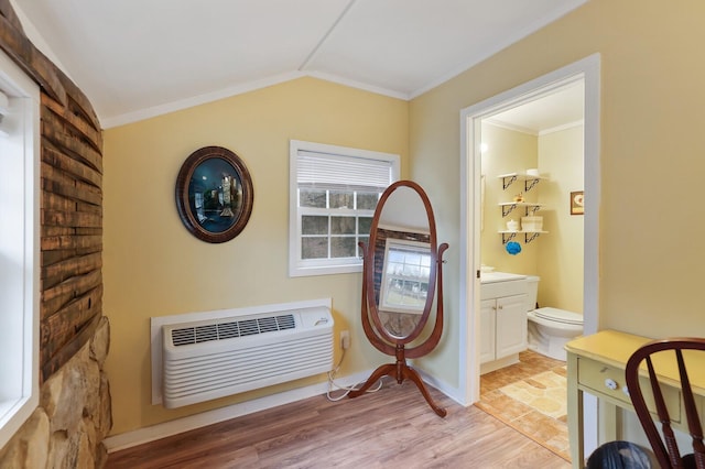 interior space featuring wood-type flooring, a wall mounted air conditioner, and ornamental molding