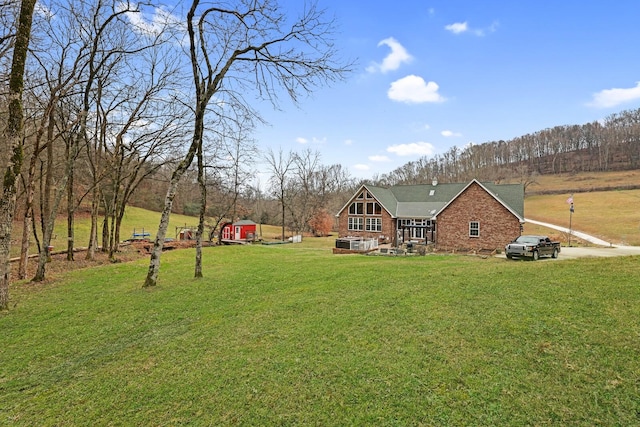 exterior space featuring a lawn and a shed