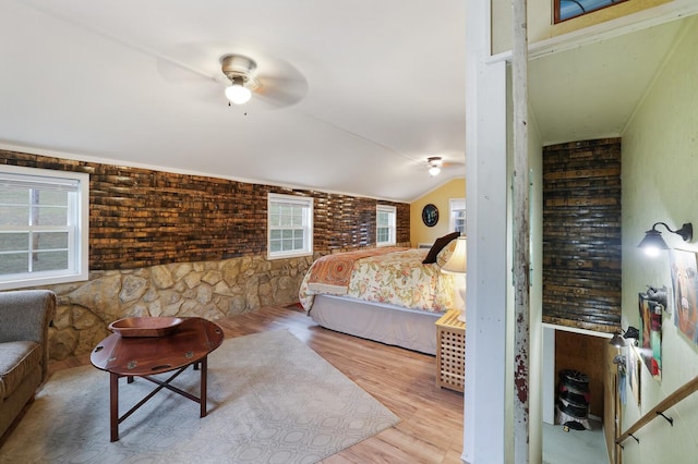 bedroom featuring multiple windows, light wood-type flooring, ceiling fan, and lofted ceiling