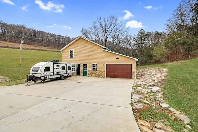 view of side of home with a yard and a garage