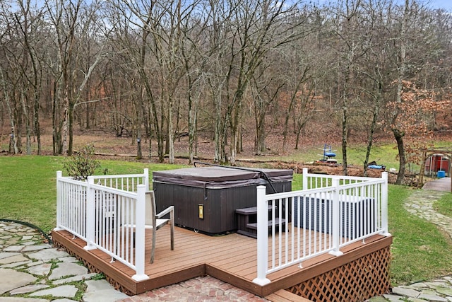 deck featuring a lawn and a hot tub