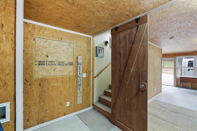 entryway with wood walls