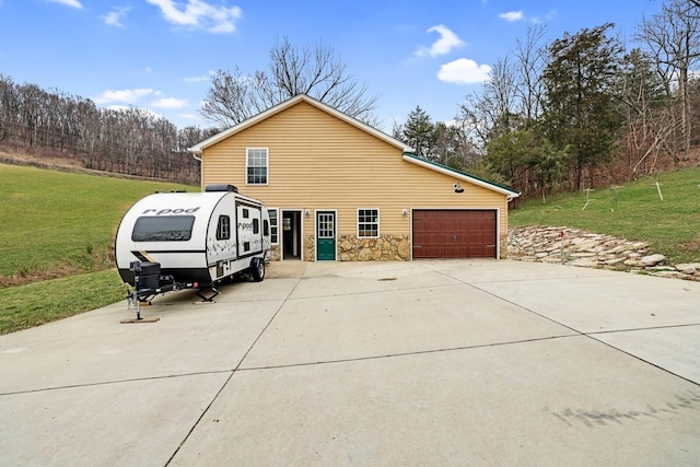 view of side of property with a garage and a lawn