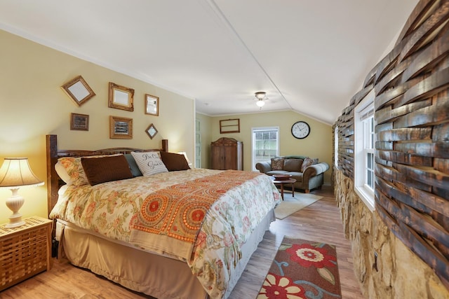 bedroom featuring light hardwood / wood-style flooring and lofted ceiling