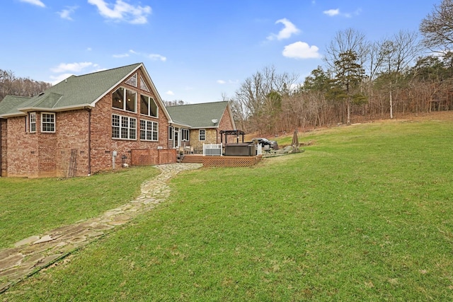 back of property with a yard and a deck