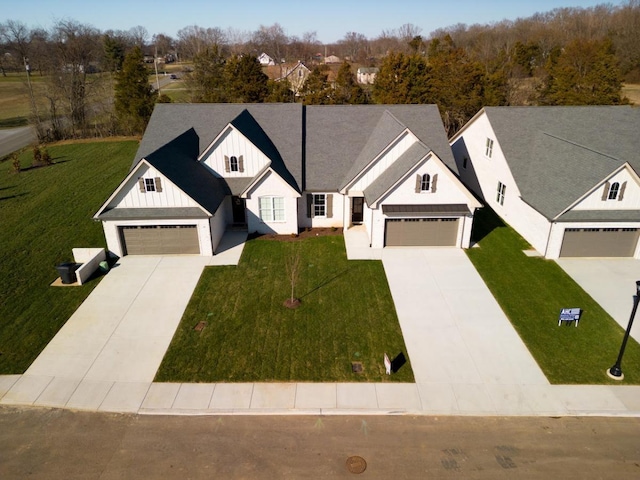 view of front of property with a garage and a front lawn