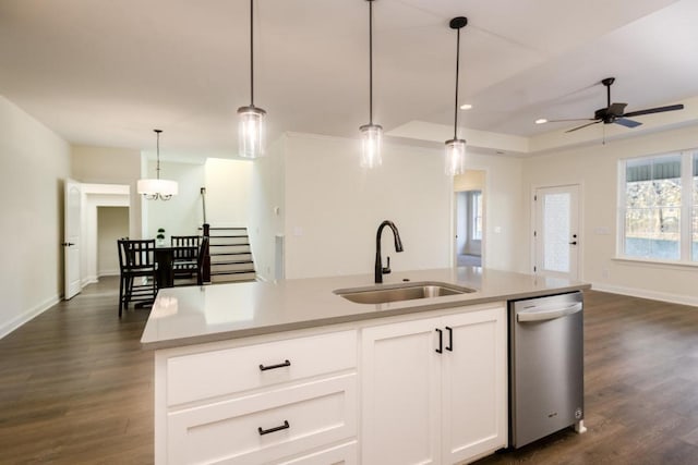 kitchen with dishwasher, a kitchen island with sink, hanging light fixtures, sink, and white cabinetry