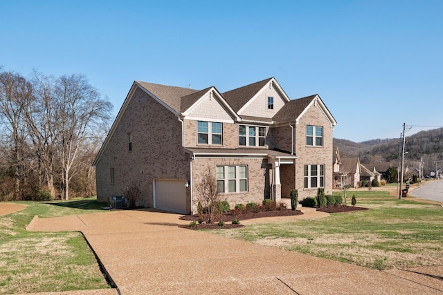 view of front facade with central AC unit, a garage, and a front lawn